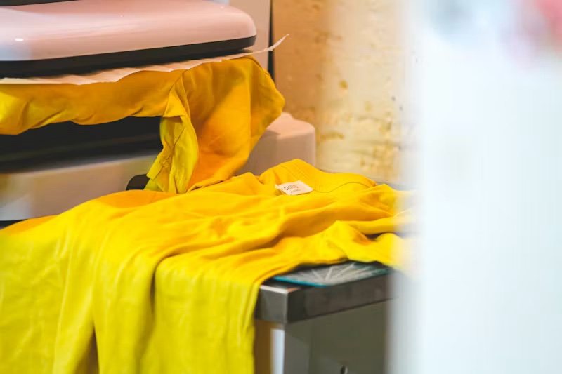 Impression DTF : t-shirt jaune sous la presse à chaud, atelier Maison Blaise